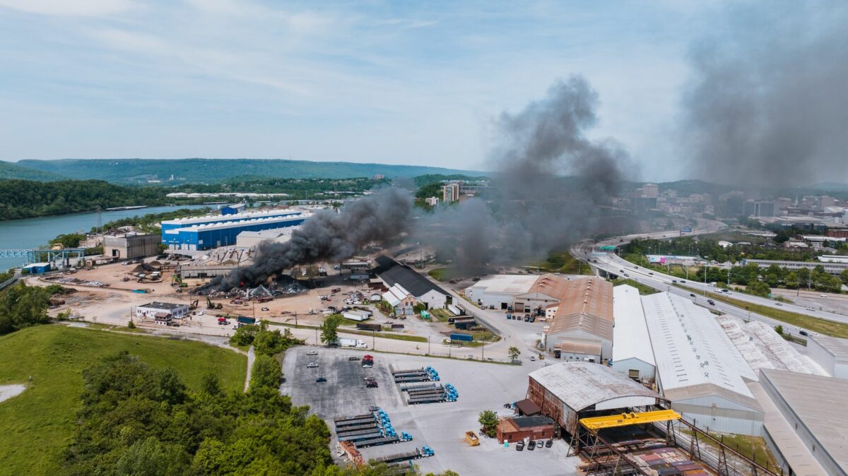 Aerial drone view of industrial fire with black smoke in Chattanooga, Tennessee.